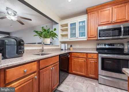 a kitchen with stainless steel appliances granite countertop a sink stove and microwave