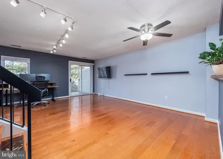 a view of empty room with wooden floor
