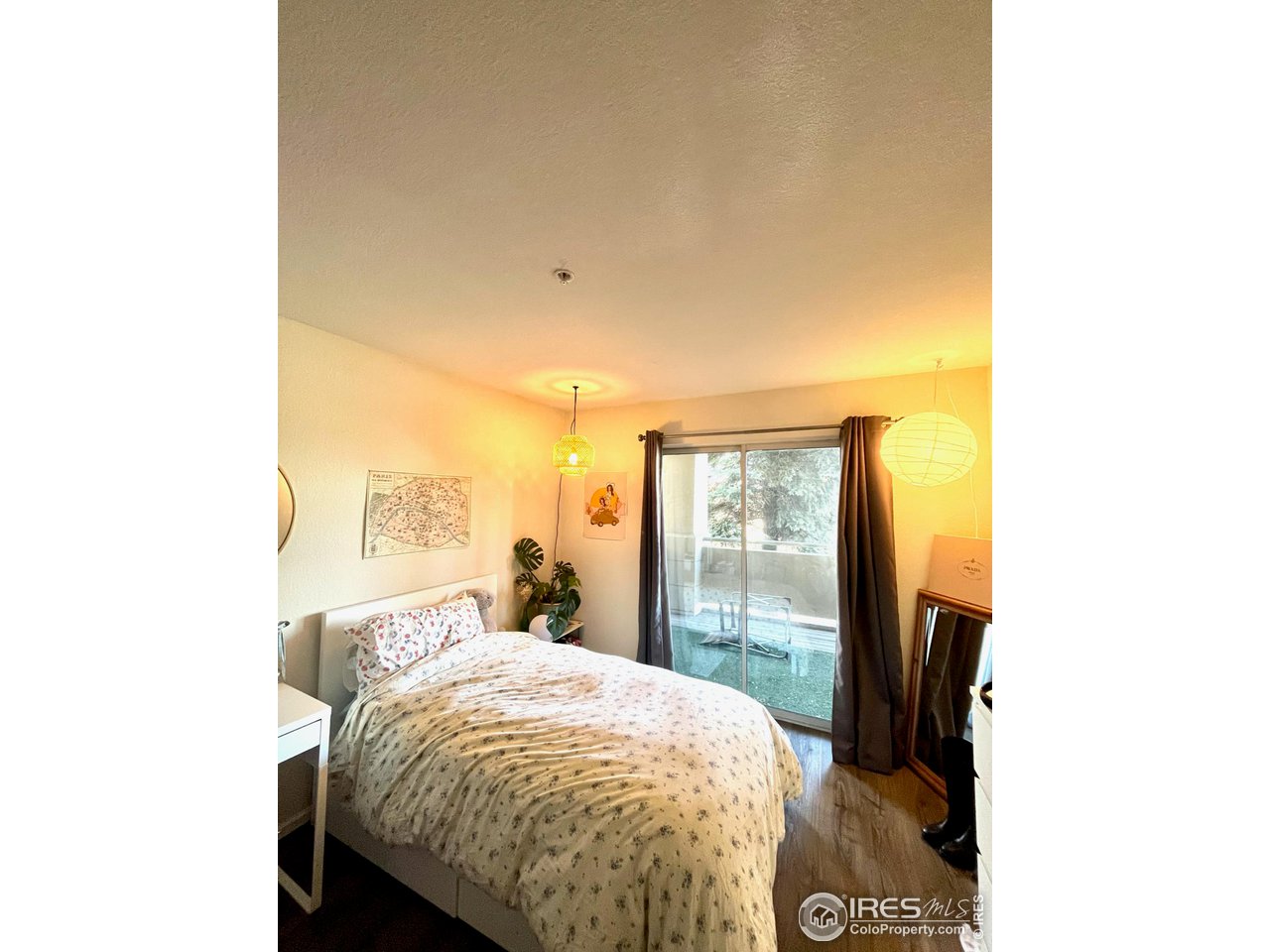 935 Broadway, Unit 106 Boulder, CO 80302 - Photo 13 of 34 a bed sitting in a bedroom next to a window