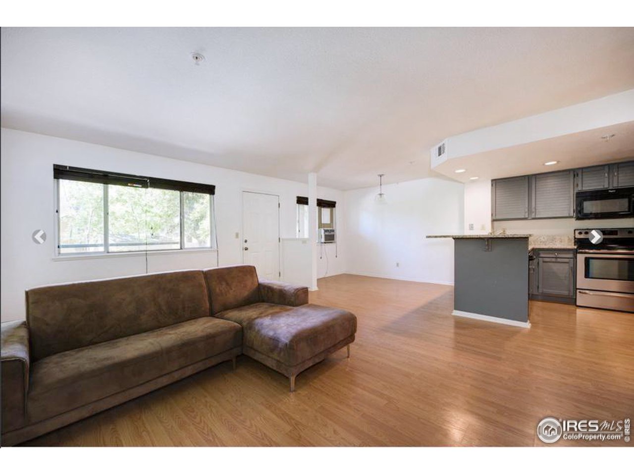 935 Broadway, Unit 106 Boulder, CO 80302 - Photo 23 of 34 a living room with furniture and a window