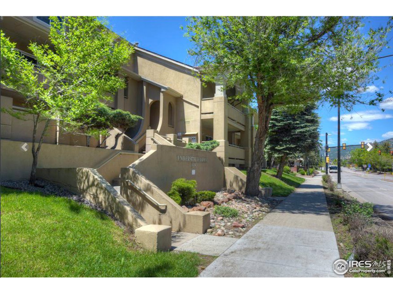 935 Broadway, Unit 106 Boulder, CO 80302 - Photo 28 of 34 a view of a backyard with table and chairs potted plants and large tree