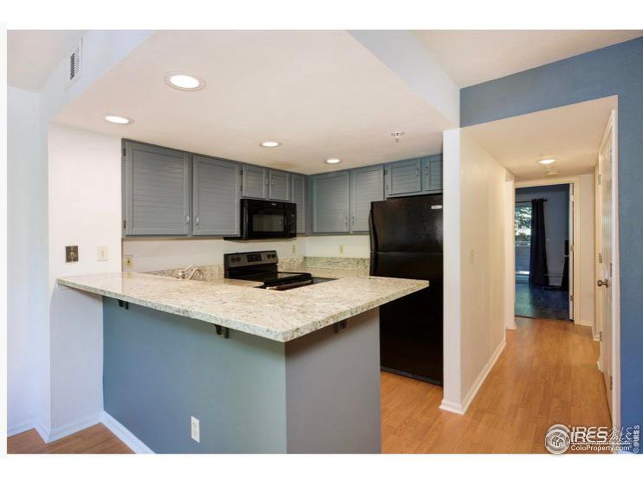 935 Broadway, Unit 106 Boulder, CO 80302 - Photo 3 of 34 a kitchen with a sink a refrigerator and cabinets