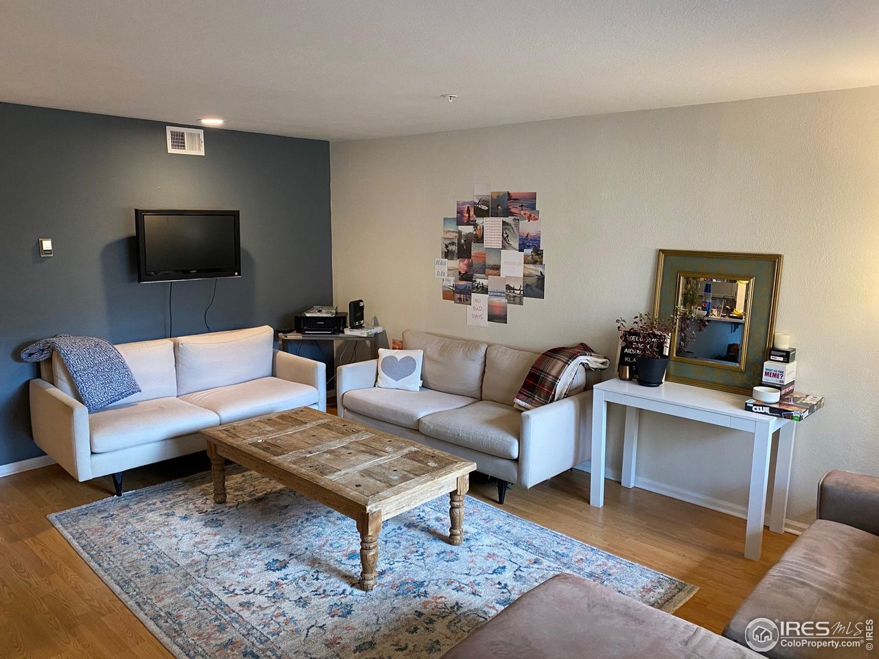 935 Broadway, Unit 106 Boulder, CO 80302 - Photo 4 of 34 a living room with furniture and a flat screen tv
