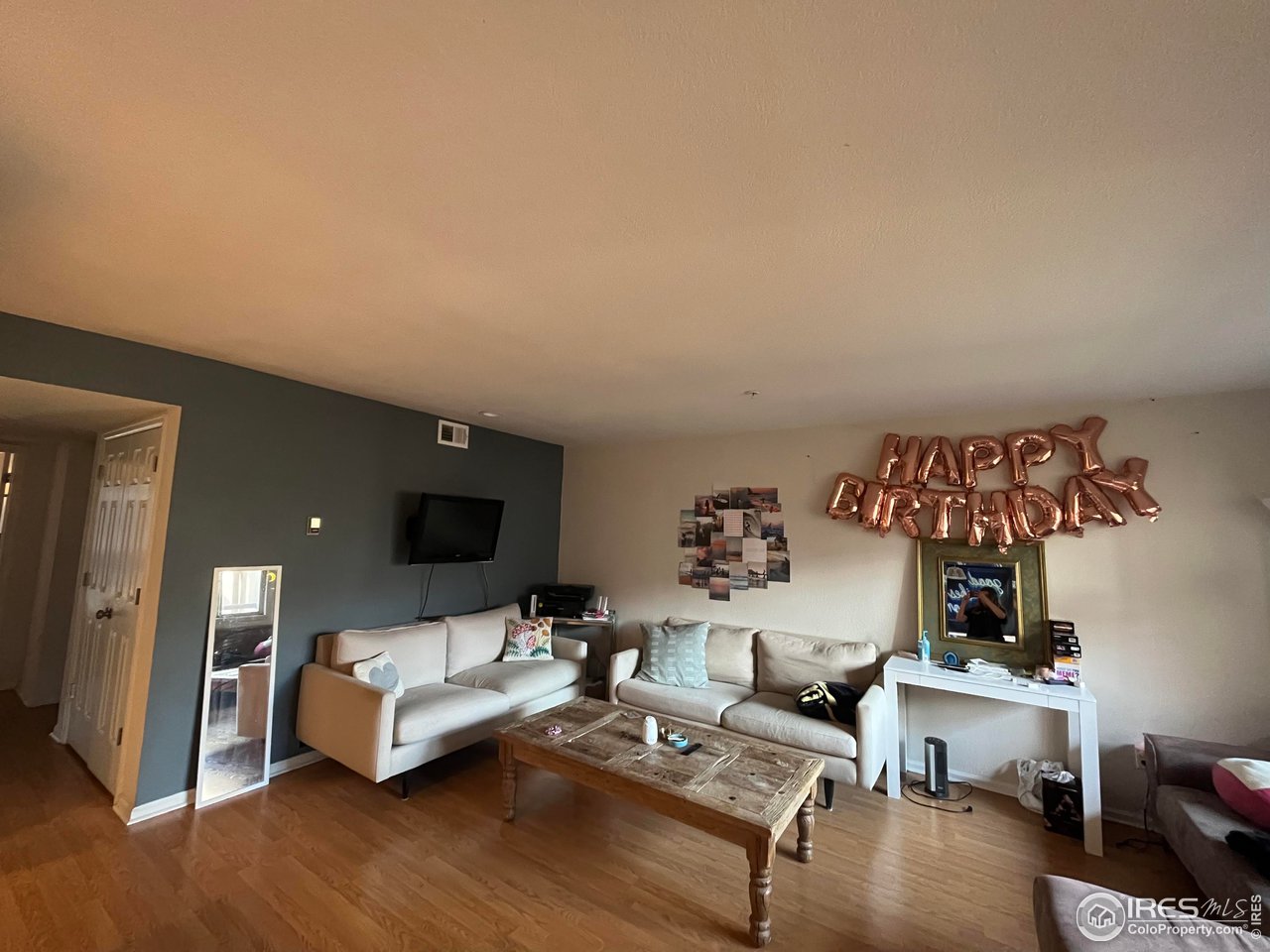 935 Broadway, Unit 106 Boulder, CO 80302 - Photo 33 of 34 a living room with furniture and a flat screen tv