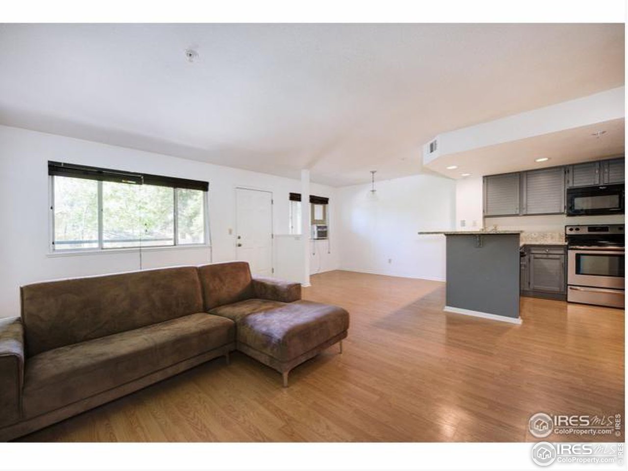 935 Broadway, Unit 106 Boulder, CO 80302 - Photo 7 of 34 a living room with furniture and a window