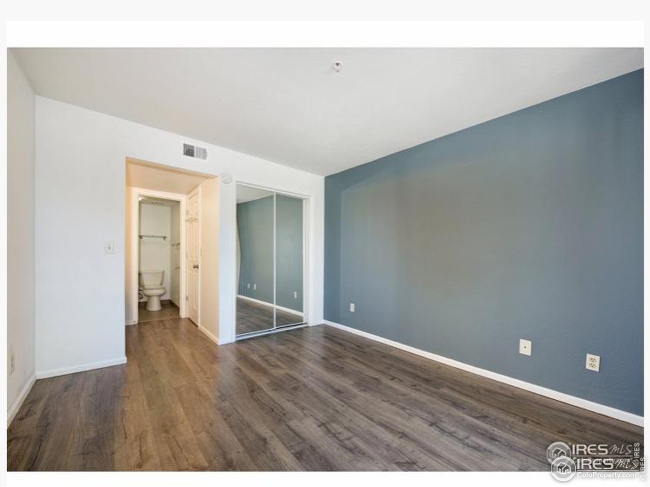 935 Broadway, Unit 106 Boulder, CO 80302 - Photo 8 of 34 a view of an empty room with wooden floor and closet