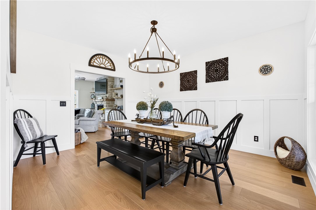 5016 Copeland Road Belton, SC 29627 - Photo 6 of 45 A classic dining area boasts rich hardwood floors and an elegant chandelier, with an open transition to the adjacent living space.