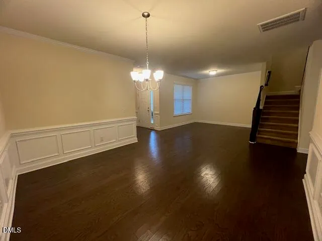 an empty room with windows and fireplace