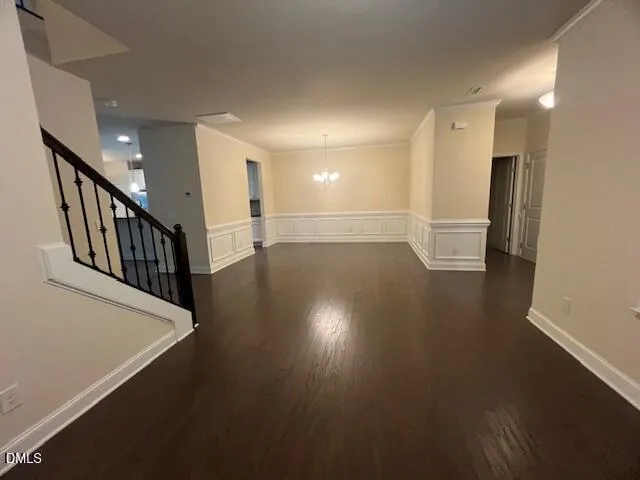 an open kitchen view with fireplace and wooden floor