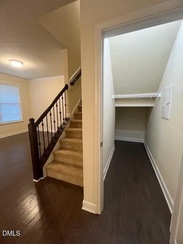 a kitchen with kitchen island granite countertop stainless steel appliances a center island a stove cabinets and a chandelier