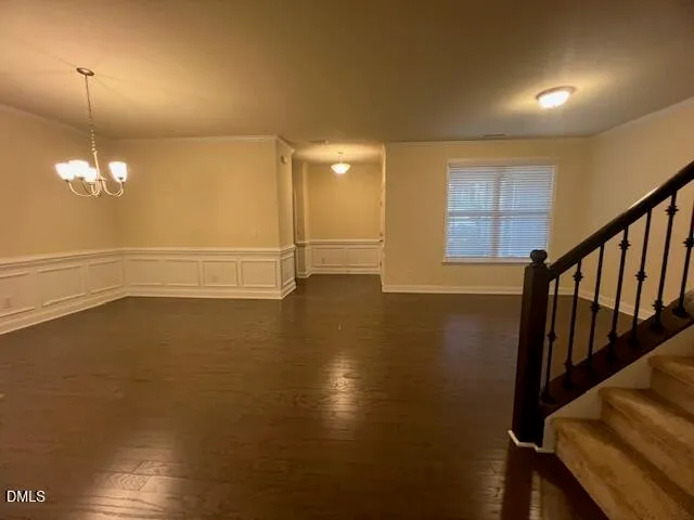 a kitchen with granite countertop a sink a stove top oven and cabinetry