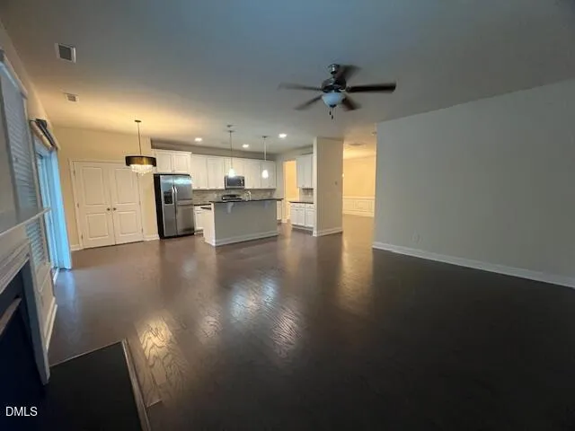 an empty room with a empty space and windows