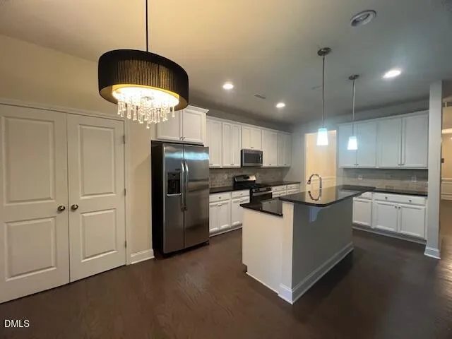 a bathroom with a bathtub sink vanity and a mirror