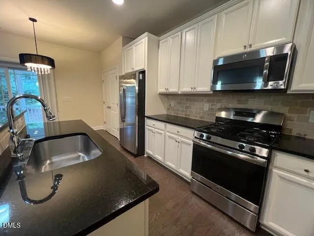 a bathroom with a sink mirror toilet and bathtub