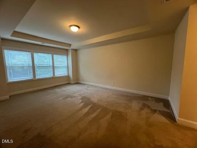 a view of a room with wooden floor chandelier and a projector