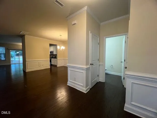 a view of a livingroom with wooden floor and staircase