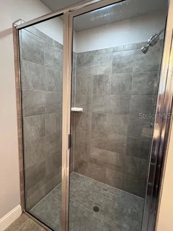 a bathroom with a glass shower door