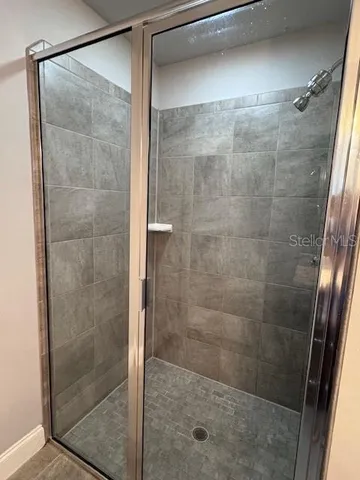 a bathroom with a glass shower door