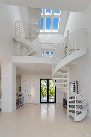 a living room with fireplace furniture and a large window or chandelier