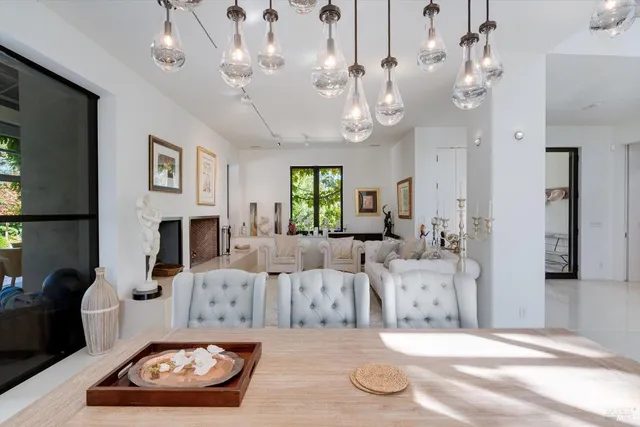 a living room with furniture potted plant and large window