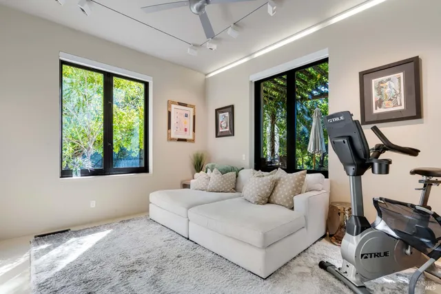 a dining room with wooden floor a glass table and chairs