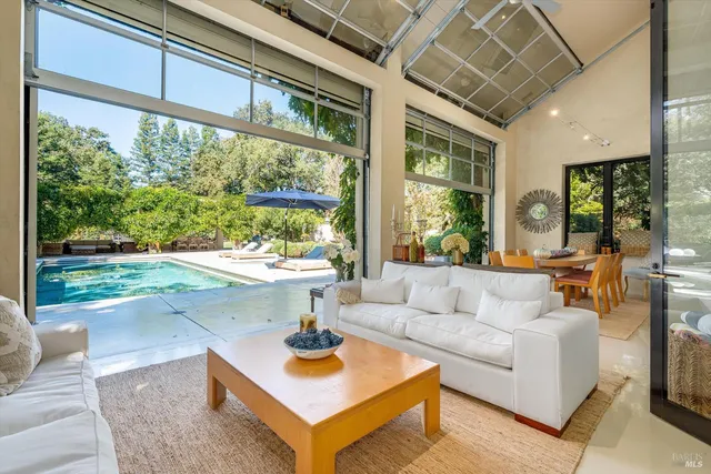 a bedroom with furniture and a large window