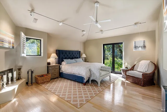 a spacious bedroom with a bed and dresser