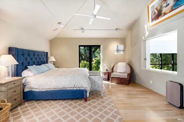 a bed room with bed and large windows