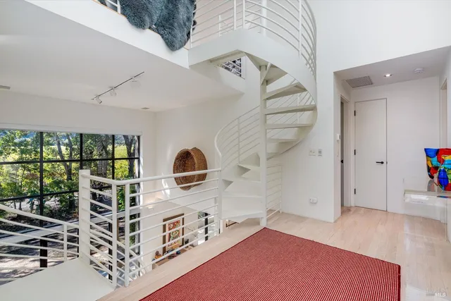 a spacious bedroom with a bed and large windows