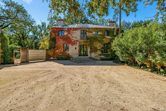 a kitchen with a sink a stove and chairs