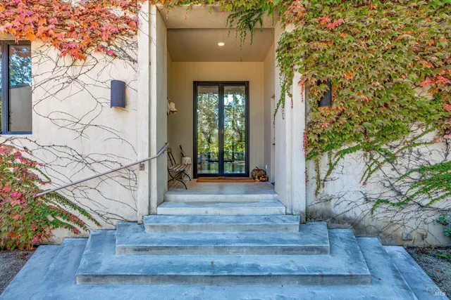 a kitchen with a sink a stove and chairs