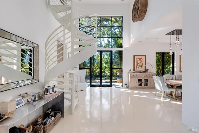 a large kitchen with stainless steel appliances a large counter top a stove a refrigerator and a sink