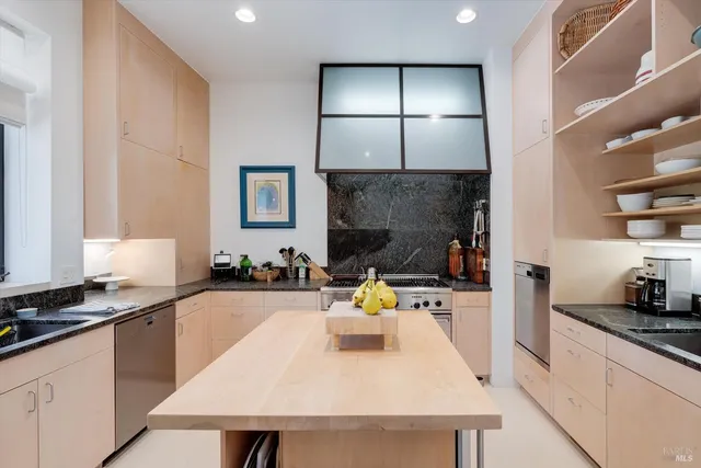a living room with furniture large window and a fireplace