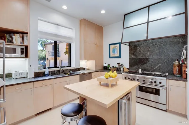 a view of a living room kitchen and a large window