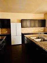 a kitchen with a sink and a refrigerator