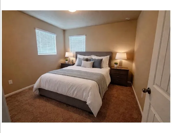 a bedroom with a bed and a night stand