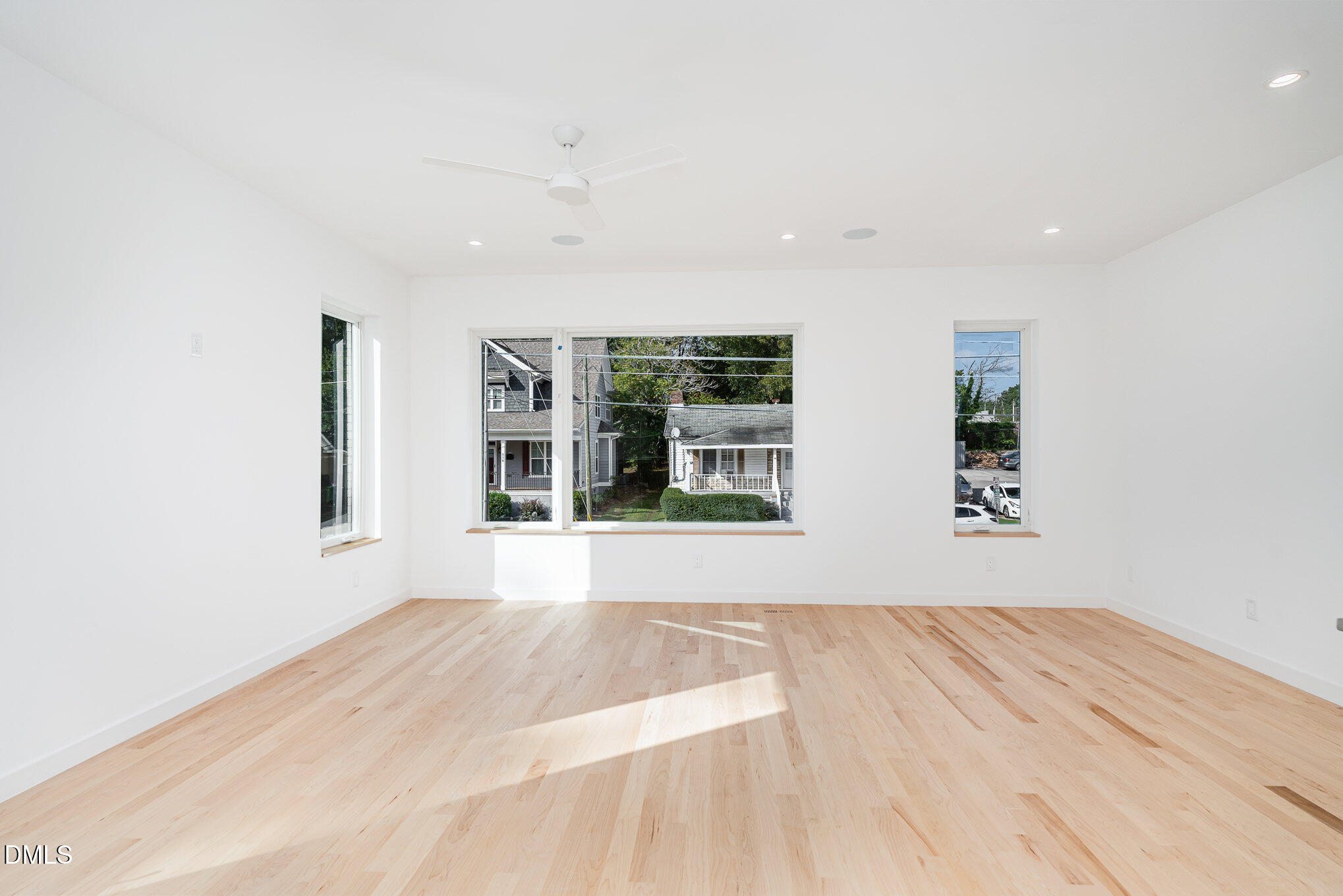 515 West Lenoir Street, Unit 102 Raleigh, NC 27601 - Photo 14 of 41 a view of an empty room with wooden floor and a window