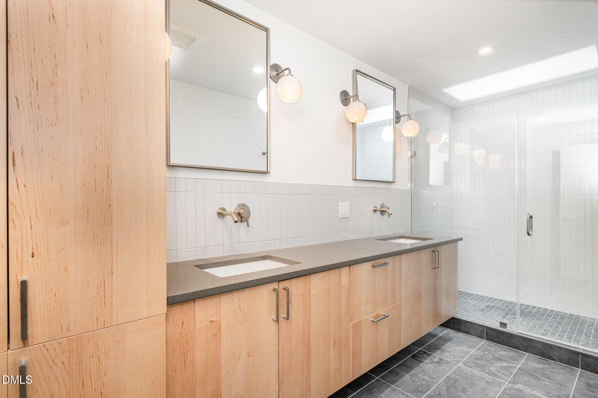 515 West Lenoir Street, Unit 102 Raleigh, NC 27601 - Photo 20 of 41 a bathroom with a sink a mirror and a bathtub