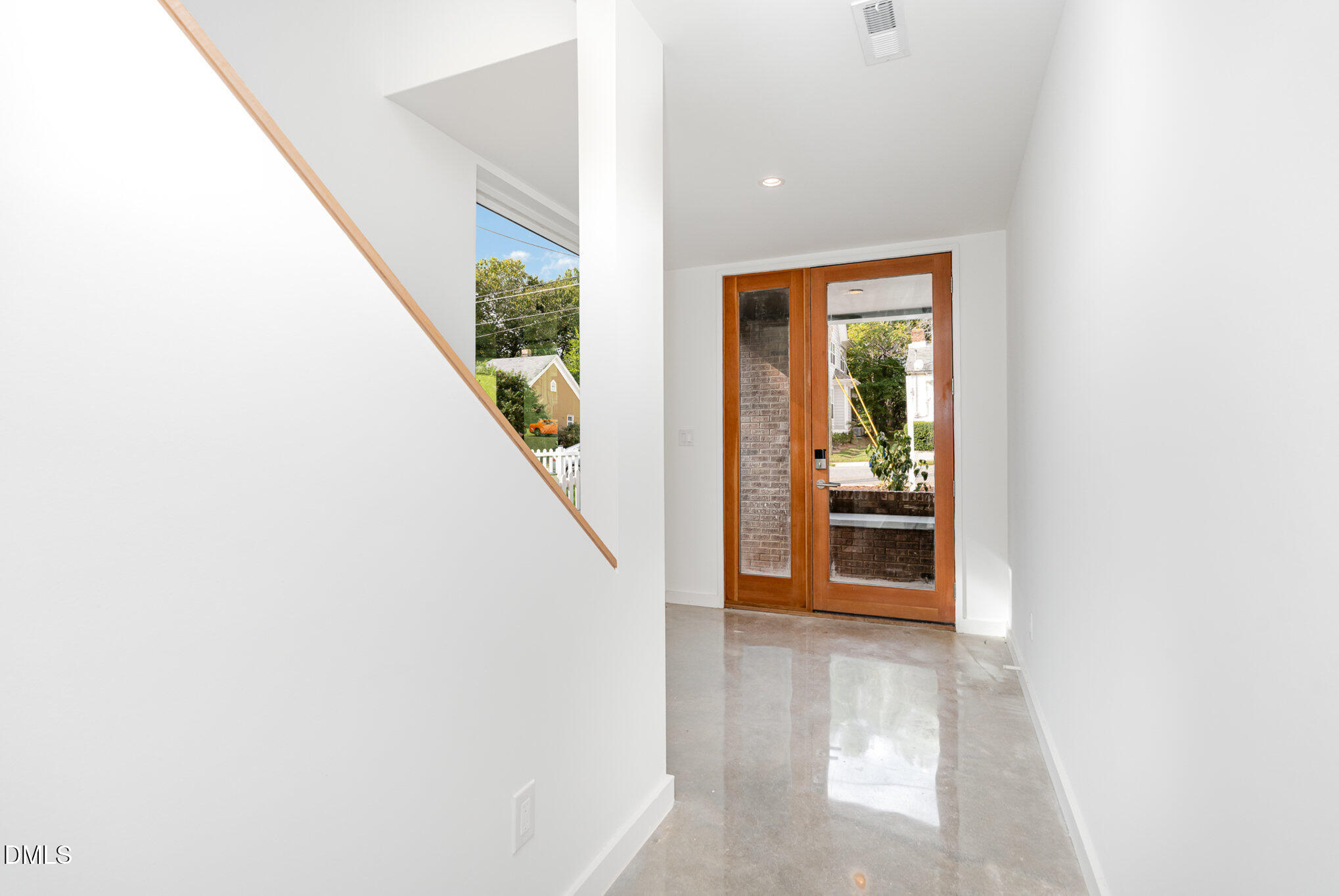 515 West Lenoir Street, Unit 102 Raleigh, NC 27601 - Photo 3 of 41 a view of a hallway with wooden floor and furniture