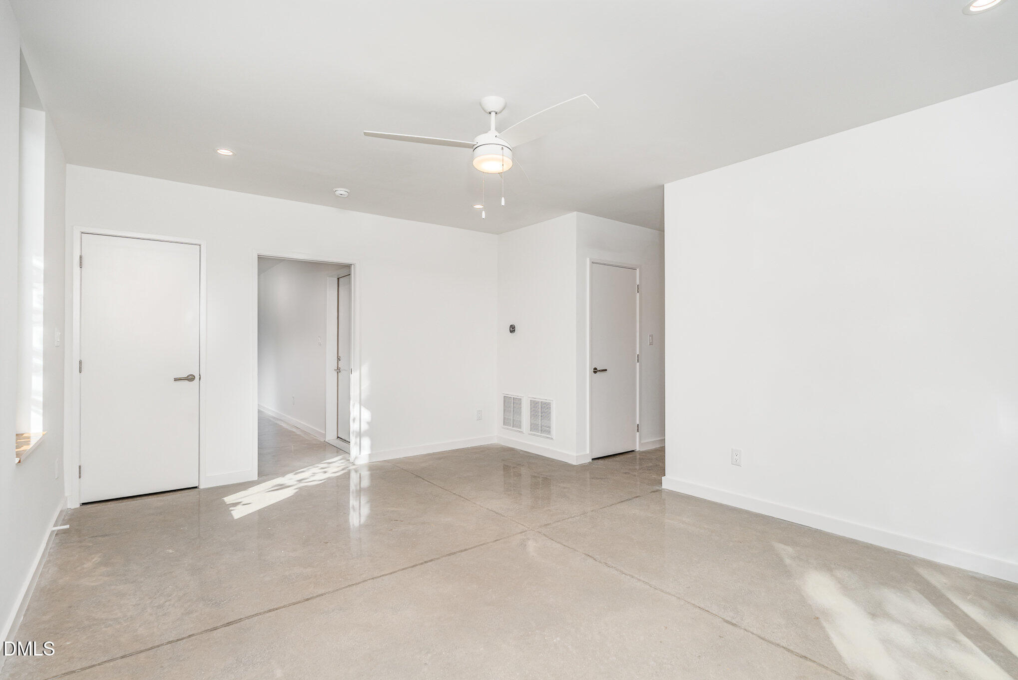 515 West Lenoir Street, Unit 102 Raleigh, NC 27601 - Photo 5 of 41 an empty room with a ceiling fan and bathroom