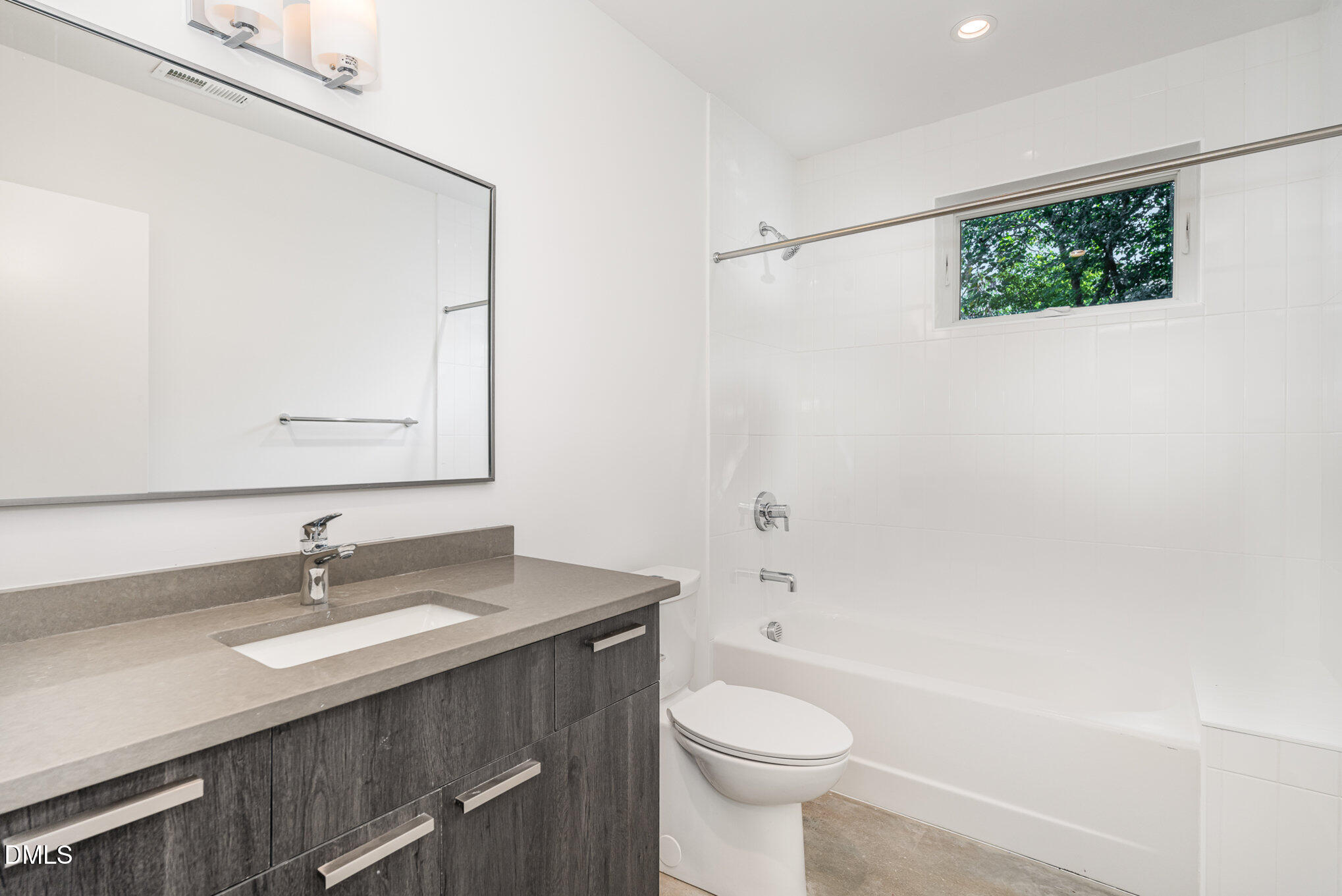 515 West Lenoir Street, Unit 102 Raleigh, NC 27601 - Photo 6 of 41 a bathroom with a sink a toilet and shower