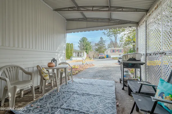 a view of a patio with table and chairs potted plants with wooden floor