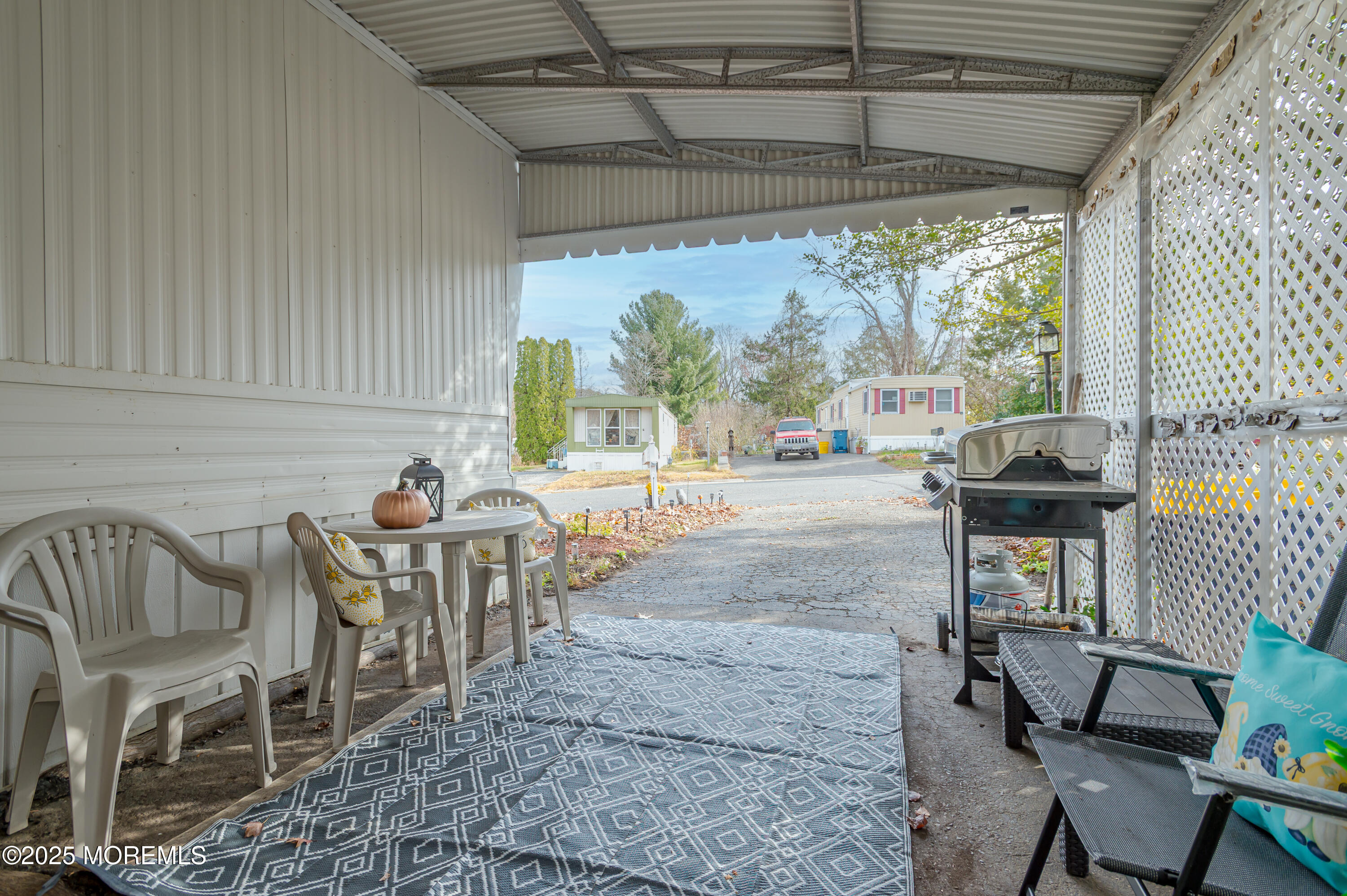 12 Alissa Terrace Jackson, NJ 08527 - Photo 5 of 18 a view of a patio with table and chairs potted plants with wooden floor