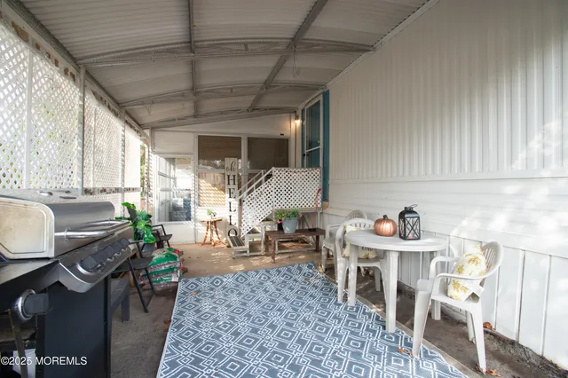 a living room with furniture a rug and a window