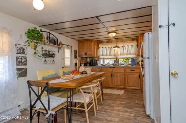 a dining room with a wooden table and chairs