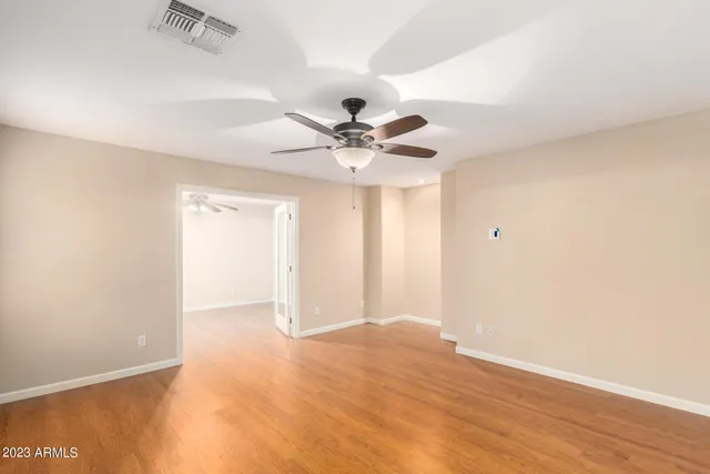 a view of an empty room with a ceiling fan