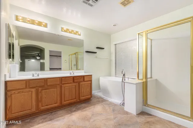 a spacious bathroom with a double vanity sink and a mirror