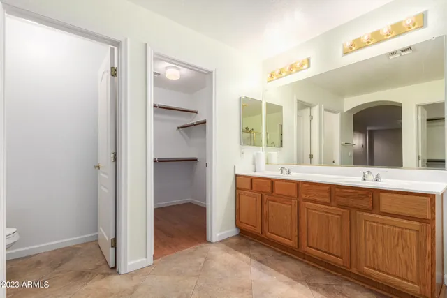 a bathroom with a sink double vanity mirror and a bathtub