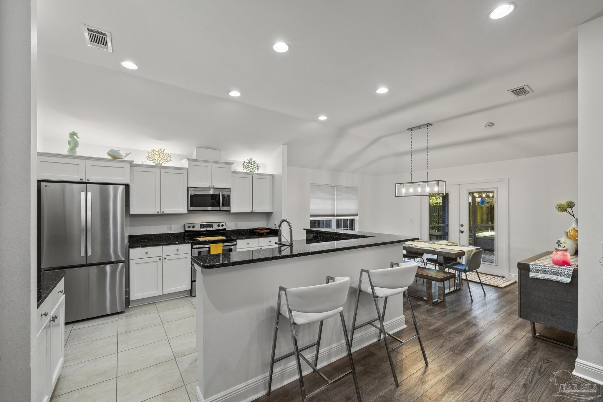 5981 Dunridge Drive Pace, FL 32571 - Photo 11 of 39 a kitchen with stainless steel appliances granite countertop a refrigerator and a stove top oven