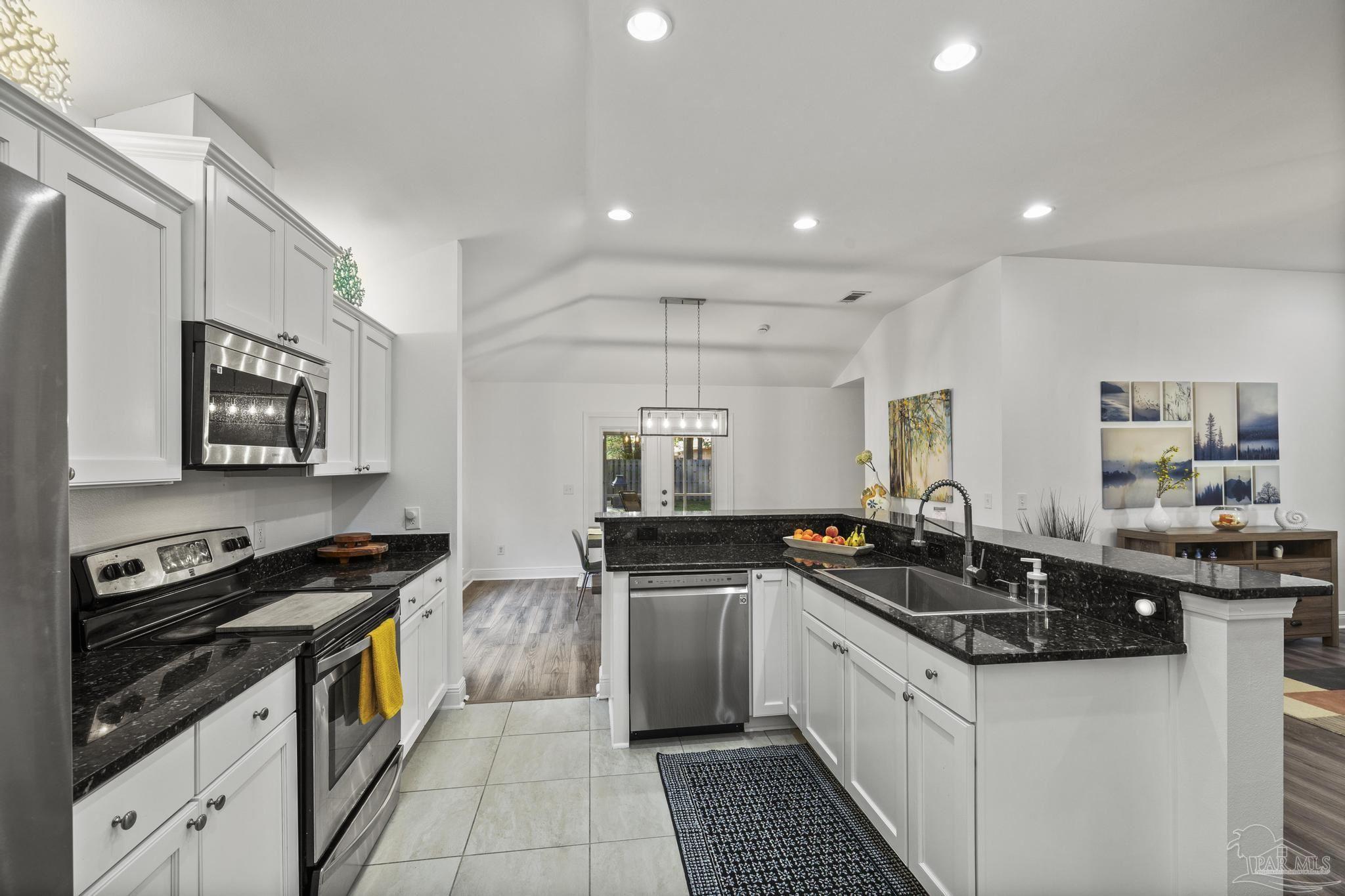 5981 Dunridge Drive Pace, FL 32571 - Photo 14 of 39 a kitchen with a sink stove top oven and microwave